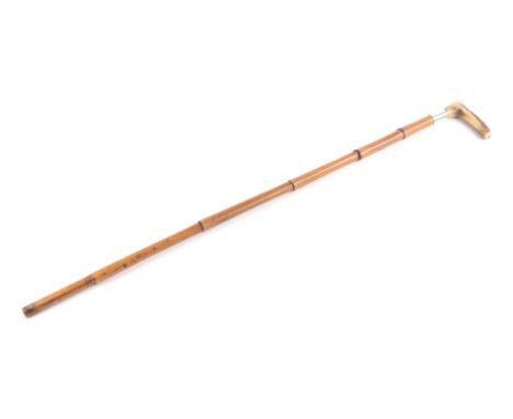 A Victorian antler handled walking stick with bamboo shaft and silver collar, 81cms long.