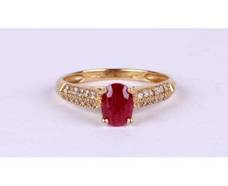 A 9ct gold dress ring set with an oval ruby and diamond set shoulders, approx UK size 'O', 2g.Condition ReportThe ruby is pro