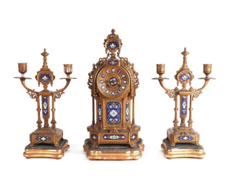 A 19th century French clock garniture, gilt spelter case with a dial having enamelled Roman numerals above cloisonné enamelle