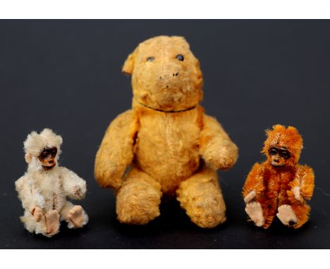 Two Schuco plush articulated monkeys, 6cms high; together with an articulated plush teddy bear, probably Steiff, 12cms high (