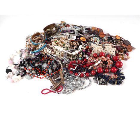 A large quantity of costume jewellery to include faux pearl necklaces, other necklaces, bangles, brooches and similar items.