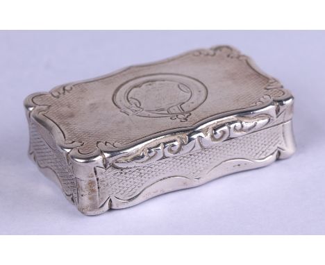 A Victorian silver snuff box of shaped rectangular form with engine turned decoration, the cover with rubbed presentation ins