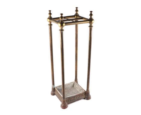 A cast iron and brass four-division stick stand, 23cms wide.