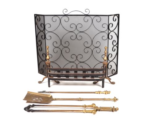 A Georgian style cast iron and brass fire grate; together with a set of brass fire irons and a wrought iron spark guard.