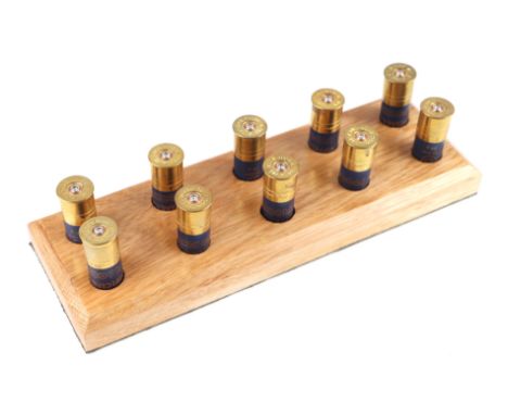 Hunting interest - A novelty shotgun shooting peg drawer / butt marker, in the form of shotgun cartridges on a solid oak base