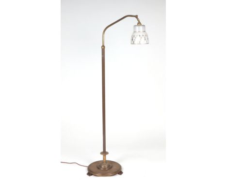 A Victorian style brass rise-and-fall standard lamp with glass shade.