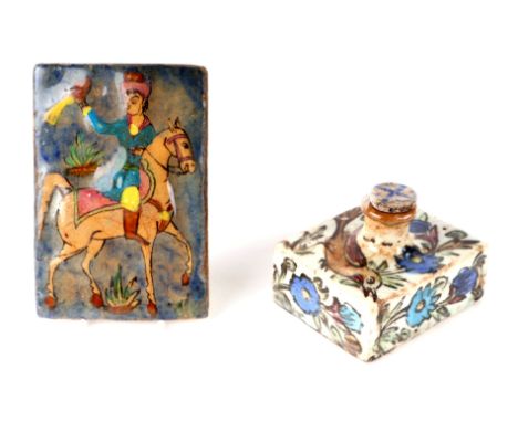 An Iznik square flask decorated with stylised flowers, 13cms wide; together with a similar tile decorated with a falconer on 