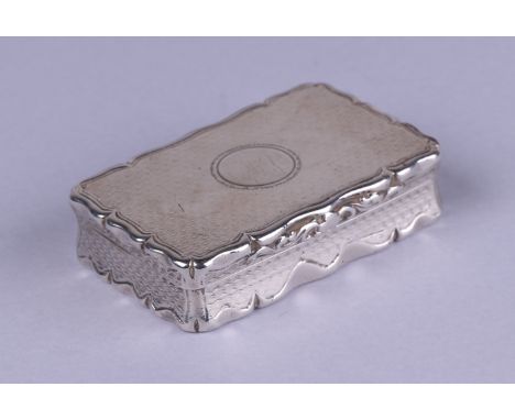 A Victorian silver snuff box of shaped rectangular form with engine turned decoration, the lid with vacant cartouche, Edward 