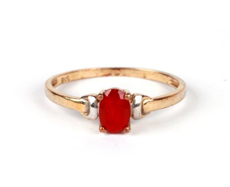 A 9ct gold dress ring set with an oval red stone (possibly synthetic ruby), approx UK size 'K', 0.9g.