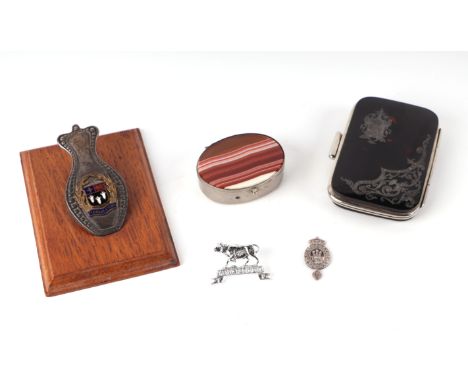 An early 20th century desk top paper tidy / clip with enamel Eton College armorial, on a wooden plinth; together with a torto