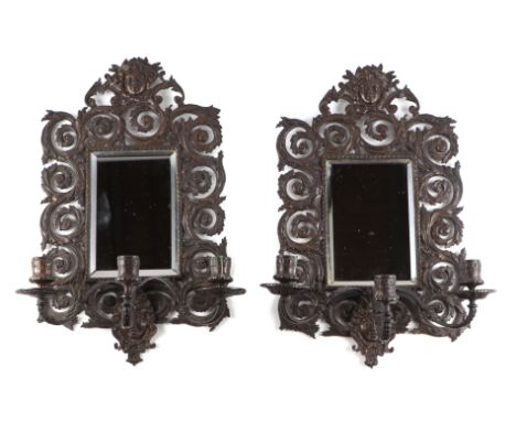 A pair of bronze mirror backed three-arm wall sconces, 27 by 44cms.