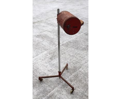A headlight beam setter on tripod base.