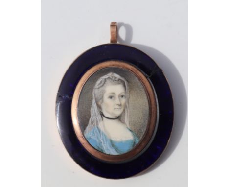 A 19th century portrait miniature on ivory, a woman wearing a veil within a yellow metal and blue enamel mount, overall 5 by 