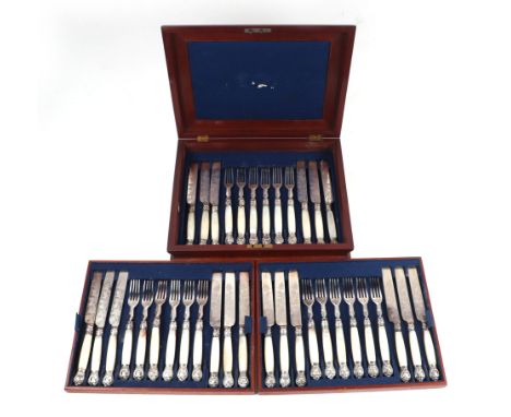 A set of eighteen late Victorian mother of pearl handled desert knives & forks with engraved blades in a mahogany case.