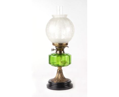 A Victorian oil lamp with green glass reservoir and etched glass shade, approx 54cms high.