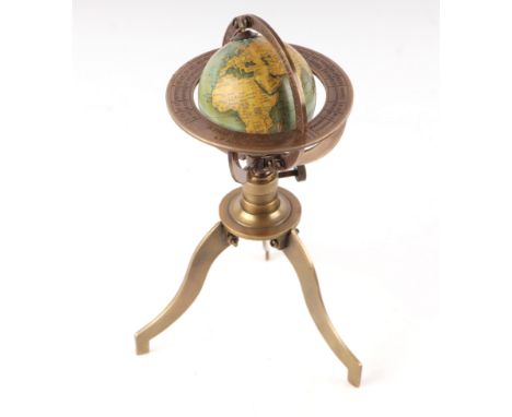 A 19th century style miniature table top terrestrial globe on a brass stand, 10cms wide.