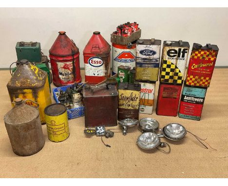 A collection of automobilia to include oil drums, oil cans, headlamps, badges, for Elf, Shell, Castro, Esso, Ford etc.