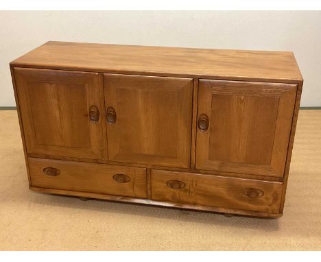 ERCOL; a sideboard on castors, with two cupboards over two drawers, a single door cupboard and cutlery drawer, height 76cm, w