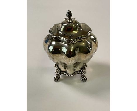 NATHAN &amp; HAYES; a late Victorian hallmarked silver tea caddy of bombe outline with hinged lid and raised on four scrollin