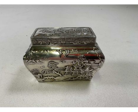 A circa 1900 Chinese white metal tea caddy with lift-off cover, inner liner and bombe body decorated with the 'Willow' patter
