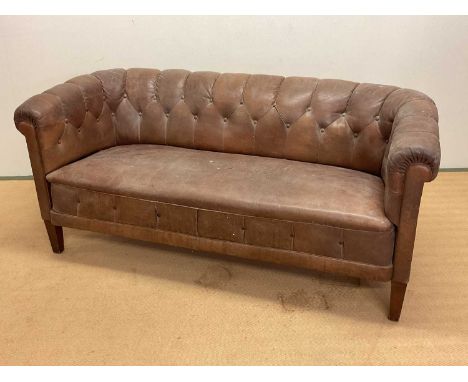 A 1930s Swedish buttonback leather sofa, height 74cm, width 165cm, depth 75cm.