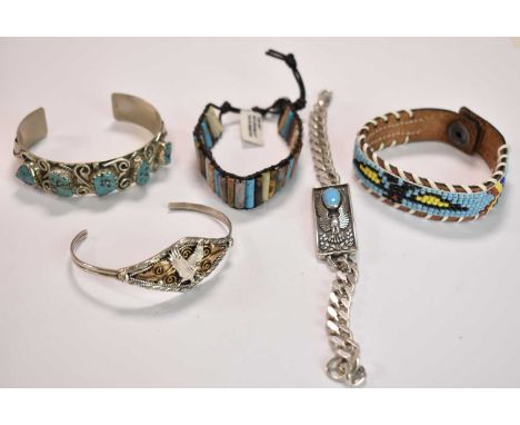 NAVAJO/NATIVE AMERICAN; a 925 grade silver bangle set with five rough cut polished pieces of turquoise and stamped 'SS', a sm