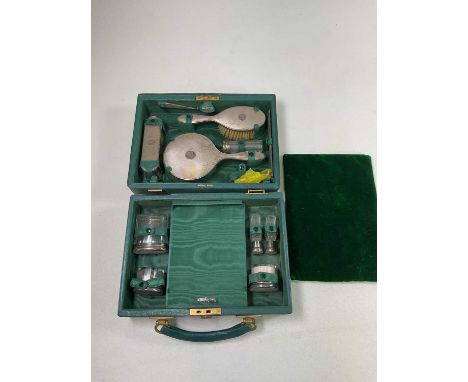 L A LEINS &amp; SONS; a George V hallmarked silver cased travelling set comprising mirror (lacking easel back), two brushes, 