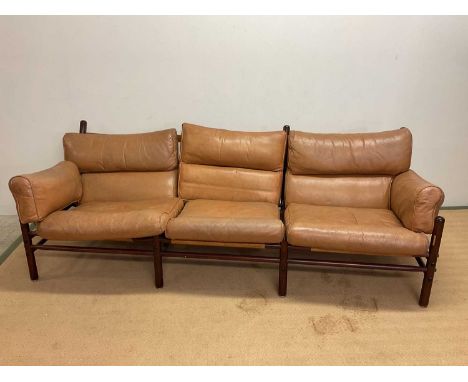 ARNE NORELL; a mid 20th century Swedish leather Kontiki three seat sofa, height at the back 76cm, width 220cm, depth 85cm.Con