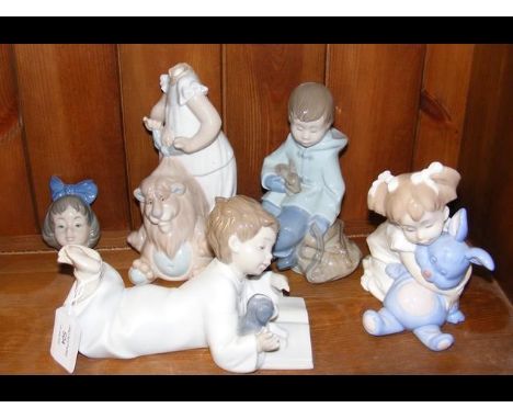 A cluster of four 'Nao by Lladro' figurines, including one of a girl with rabbit 