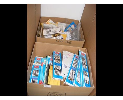 A box of train accessories, together with model train kits 