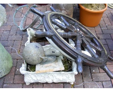 A ship's wheel, garden weather-vane, life ring, etc. 