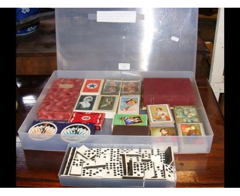 A collection of vintage playing cards and Bridge score cards, together with dominoes 