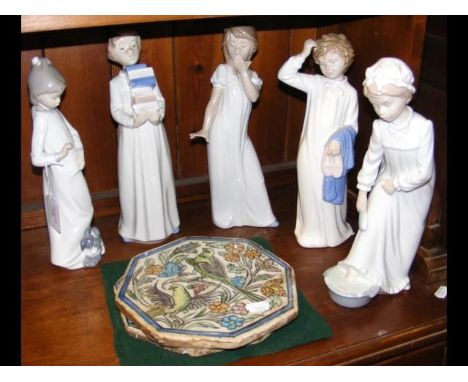 Five large 'Nao by Lladro' figurines, together with two octagonal tiles sporting birds 