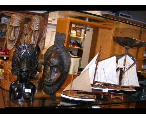 An African hardwood mask, other wooden figures, together with three model sailing boats