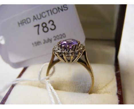 An amethyst and diamond ring in gold setting