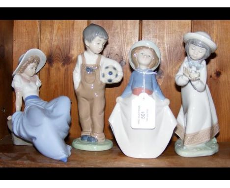 A cluster of four 'Nao by Lladro' figurines, including one of a boy with football 