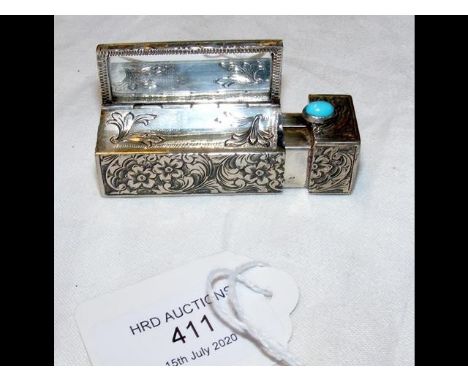 An 800 marked silver lipstick case with turquoise cabochon button 