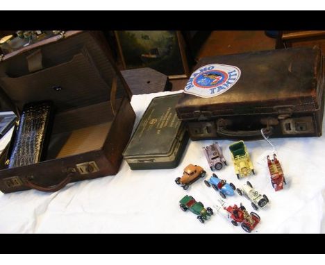 A vintage crocodile style suitcase, one other together with diecast toys and an alligator skin handbag