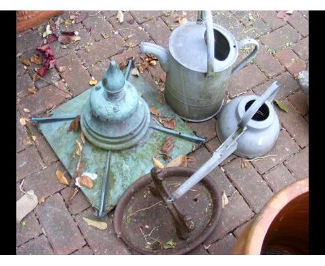 A galvanized watering can and one other, together with a light finial and boot scraper 