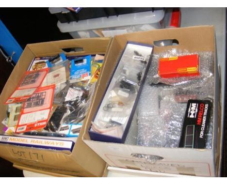 A box containing model train accessories and one other 