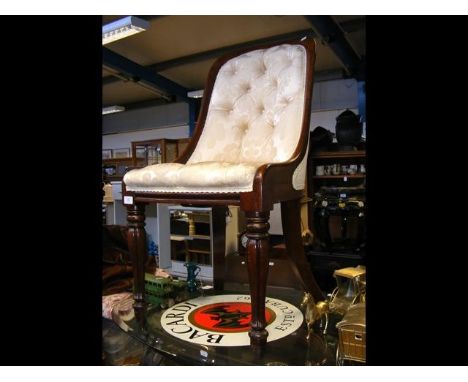 An antique button back nursing chair