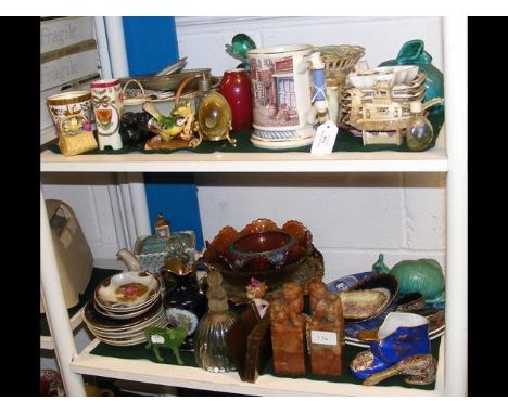 Various collectable ceramic and glassware, including a pair of soap stone carvings - on two shelves 