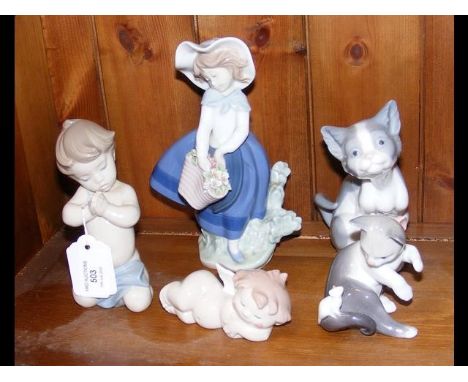 An assortment of five Lladro and 'Nao by Lladro' figurines, including several of cats 