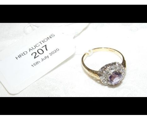 An amethyst? and diamond ring in gold setting  