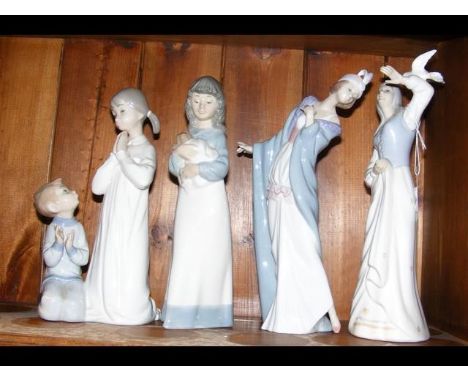 An assortment of four Lladro, 'Nao by Lladro' and similar style figurines, including one of praying children 