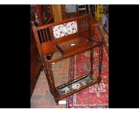 An Edwardian hall umbrella/stick stand with tiled back 