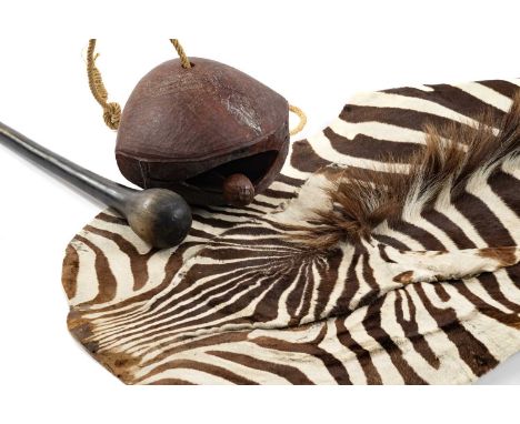 THE FIELD SPORTS CLUB HOUSE: ZEBRA SKINS & ETHNOGRAPHIC ITEMS, including Zulu horn knobkerrie, wood camel bell, and partial s