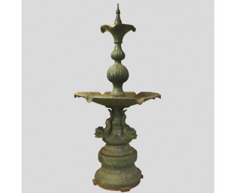 the multi-tiered and circular form raised on an ornate base with mythical dolphins, beading, foliate and scale motifs, height