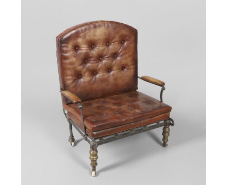 the adjustable metal reclining back support on tubular steel and turned brass legs, with three later leather button back cush