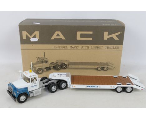 First Gear - A boxed First Gear 1:34 scale R-Model Mack with Lowboy Trailer diecast model truck. The truck appears to be in M